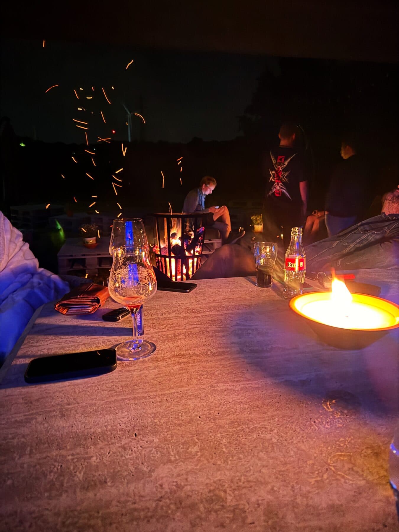 GreyHouse Bar fire pit at night with sparks